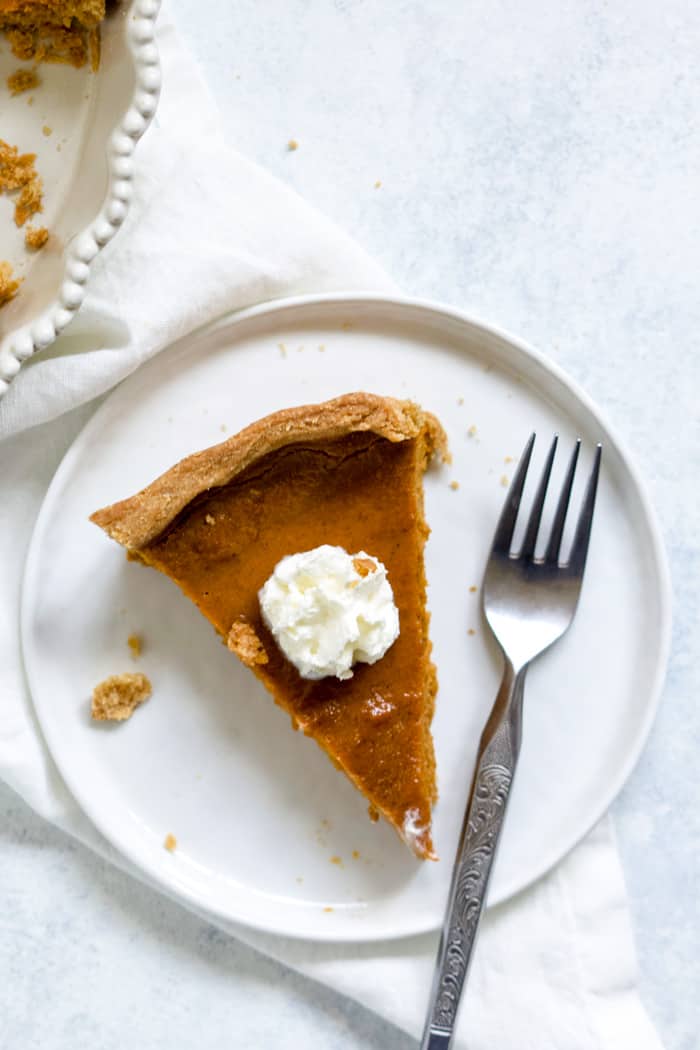 Slice of blender maple pumpkin pie with whipped cream