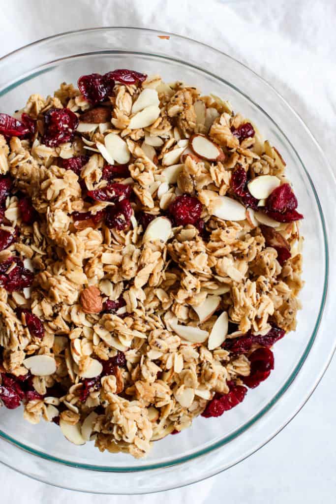 Cranberry almond granola in large clear bowl