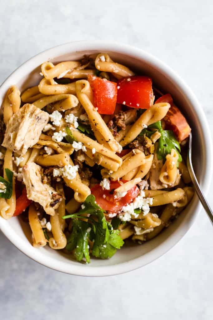 Olive tapenade and tuna pasta salad in white bowl