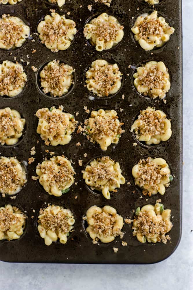 Mac and cheese topped with breadcrumbs in mini muffin tin cups