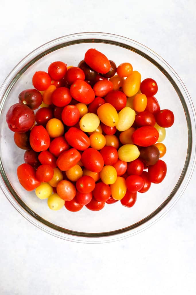 Cherry and grape tomatoes in clear glass bowl
