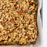 Healthy pumpkin granola in parchment paper-lined sheet pan