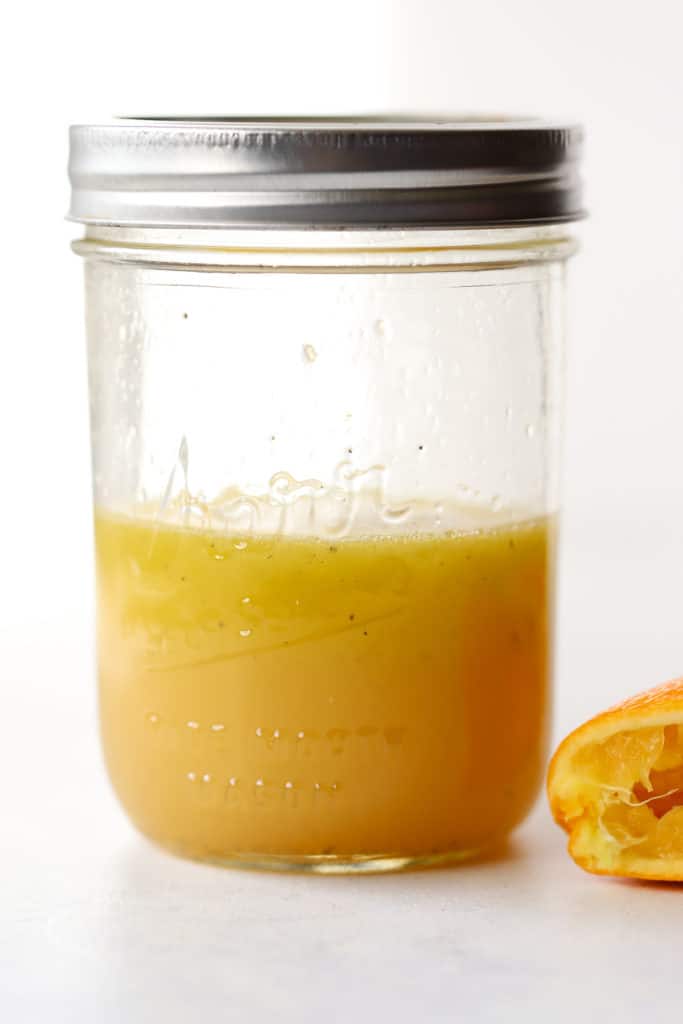 Simple orange vinaigrette shaken in glass mason jar