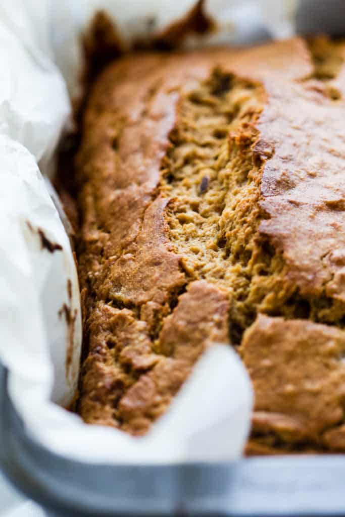 Spelt flour banana bread in bread pan lined with parchment paper