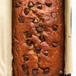 Spelt flour banana bread with chocolate chips in loaf pan lined with parchment paper