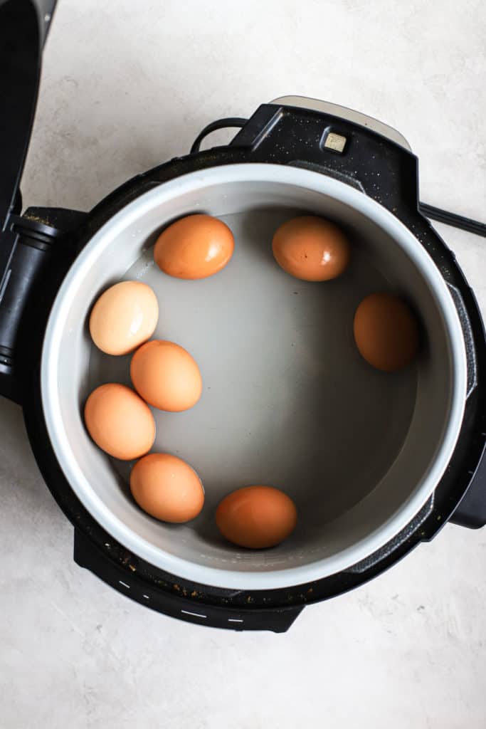 Brown eggs and water in Ninja Foodi pressure cooker