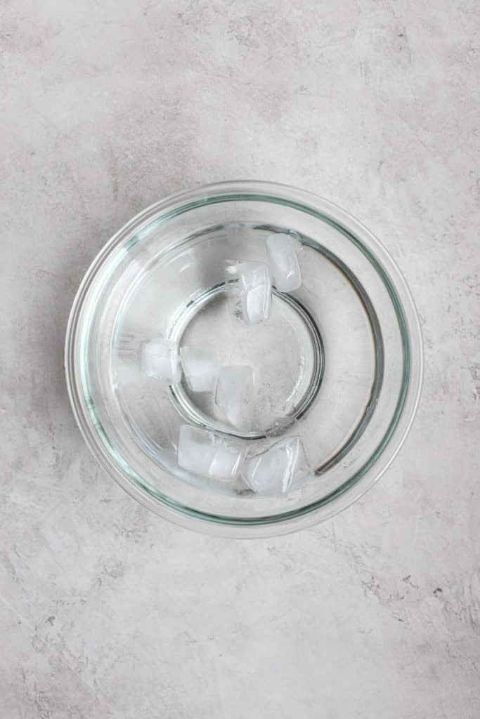 Ice water in clear glass bowl