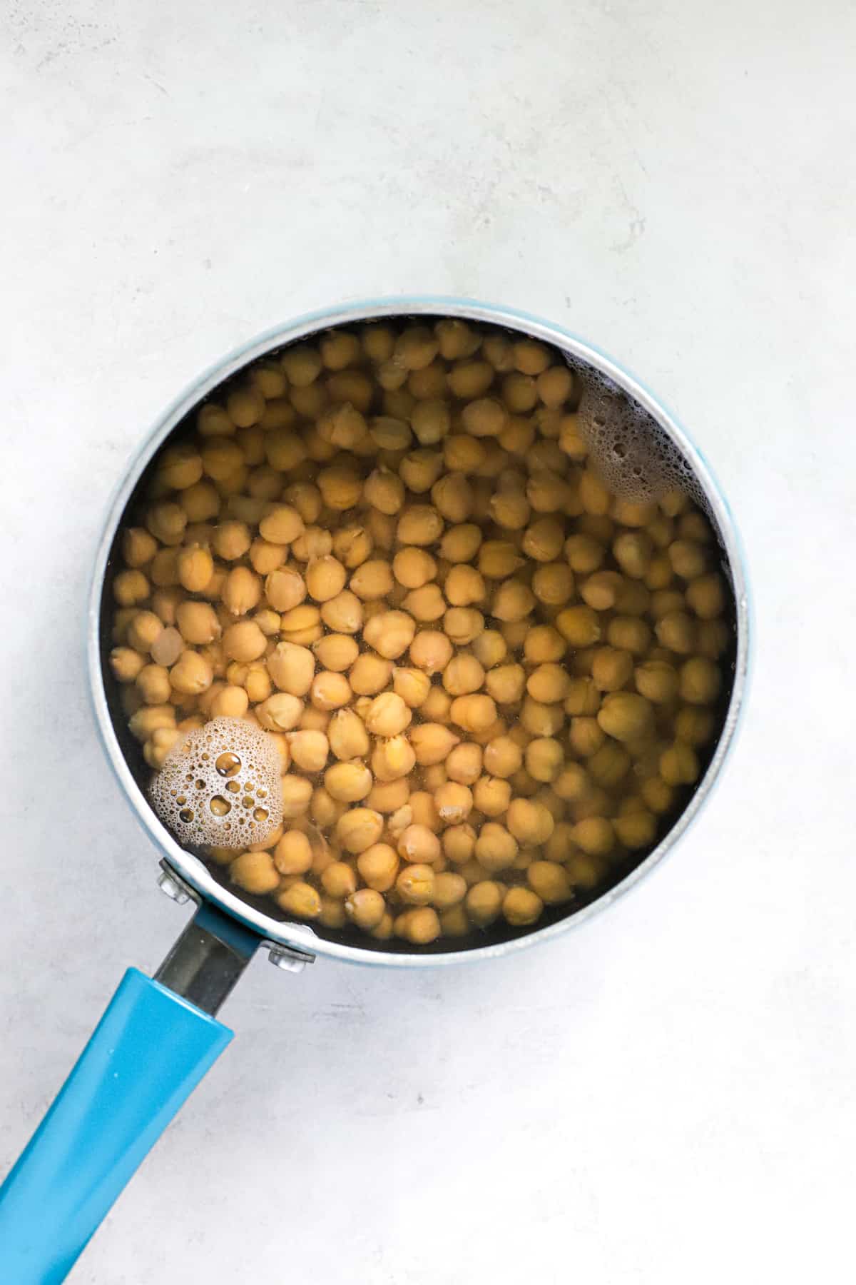 Chickpeas and baking soda in small blue pot